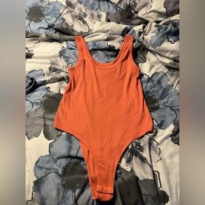 Orange target body suit. Size large